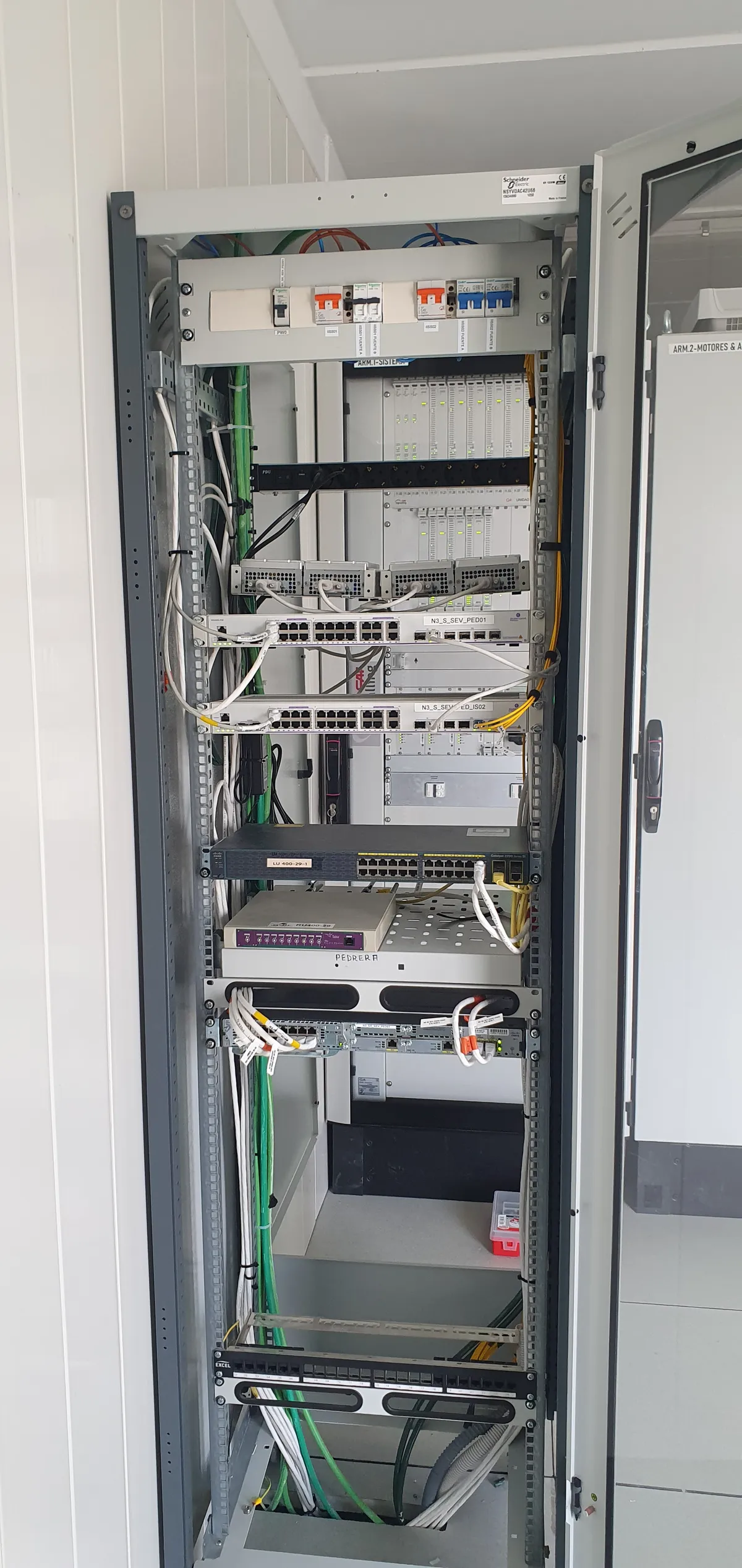 Technical communications cabinet with DC power supply, control electronics and organized cabling in a critical infrastructure environment